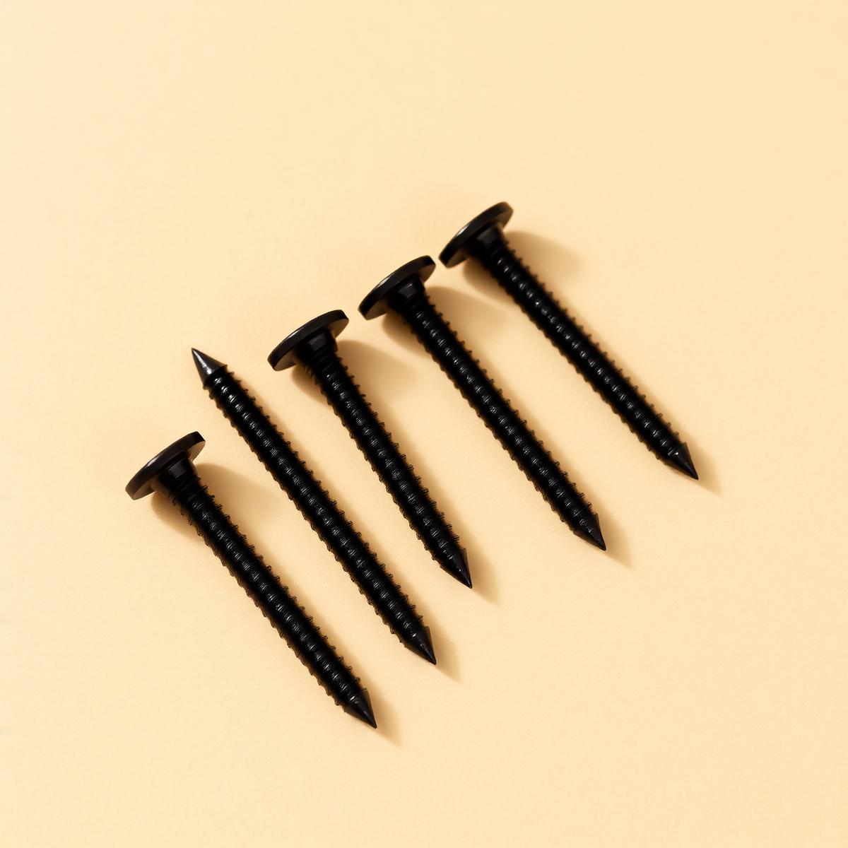 Black drywall screws in a row